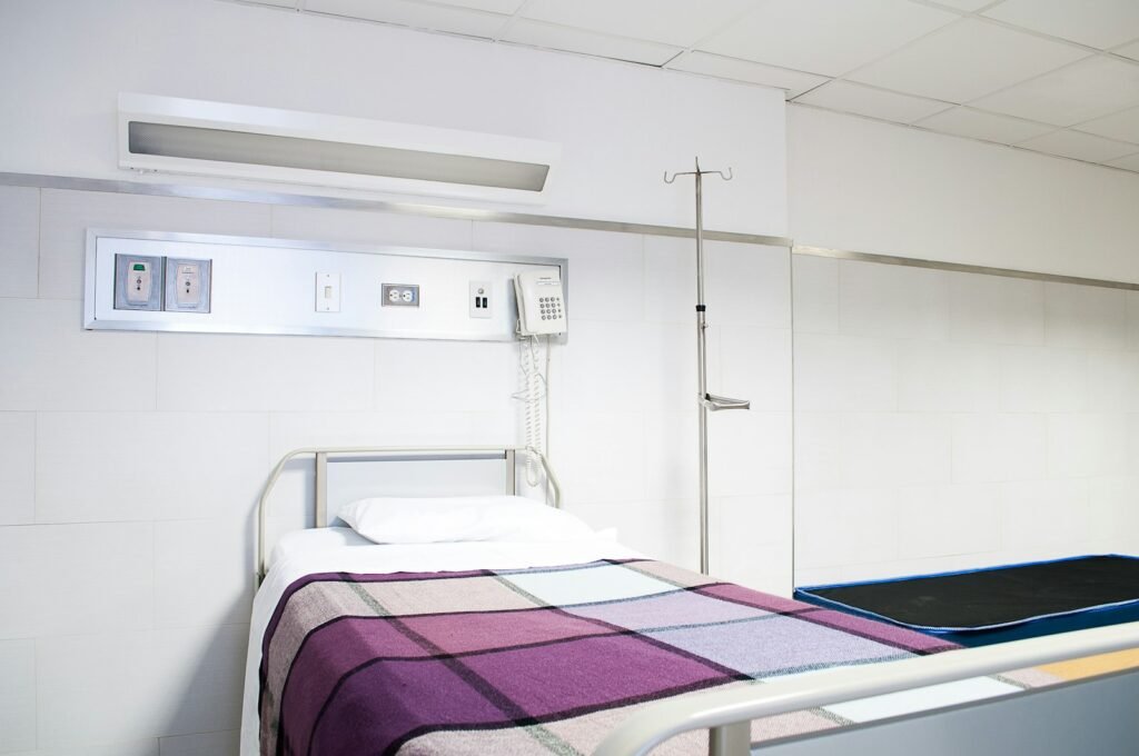 Empty hospital bed in a quiet room, reflecting recovery while living with a Bard PowerPort injury