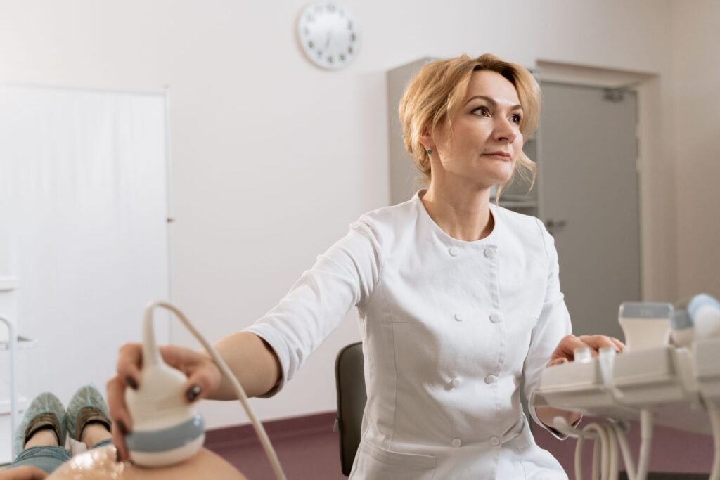 Female doctor performing an ultrasound, one of the tests used to check for mesh complications