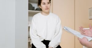 Woman discussing her transvaginal mesh lawsuit deadline and medical history with a doctor during a clinic consultation