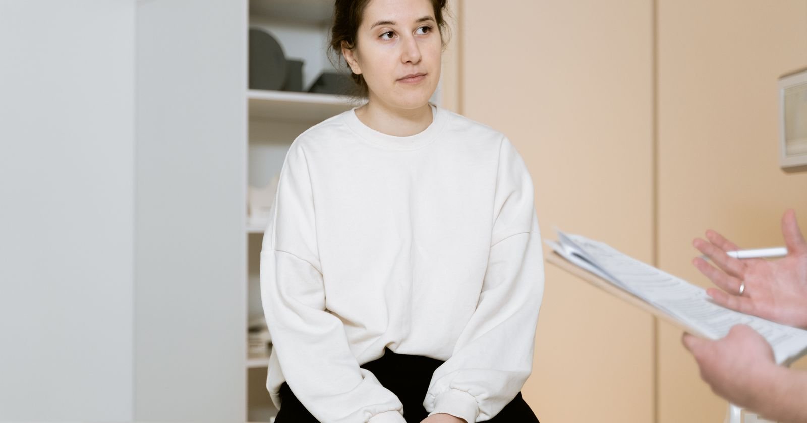Woman discussing her transvaginal mesh lawsuit deadline and medical history with a doctor during a clinic consultation