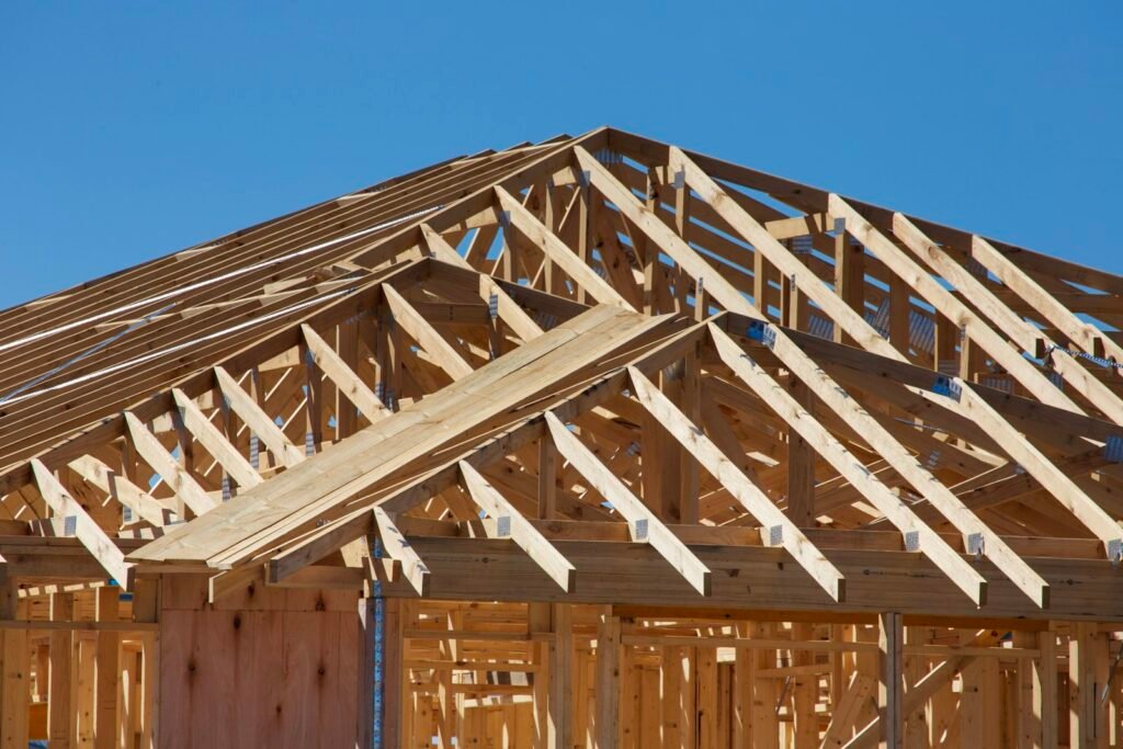 New wooden house framing and roof trusses during construction of a rebuilt home