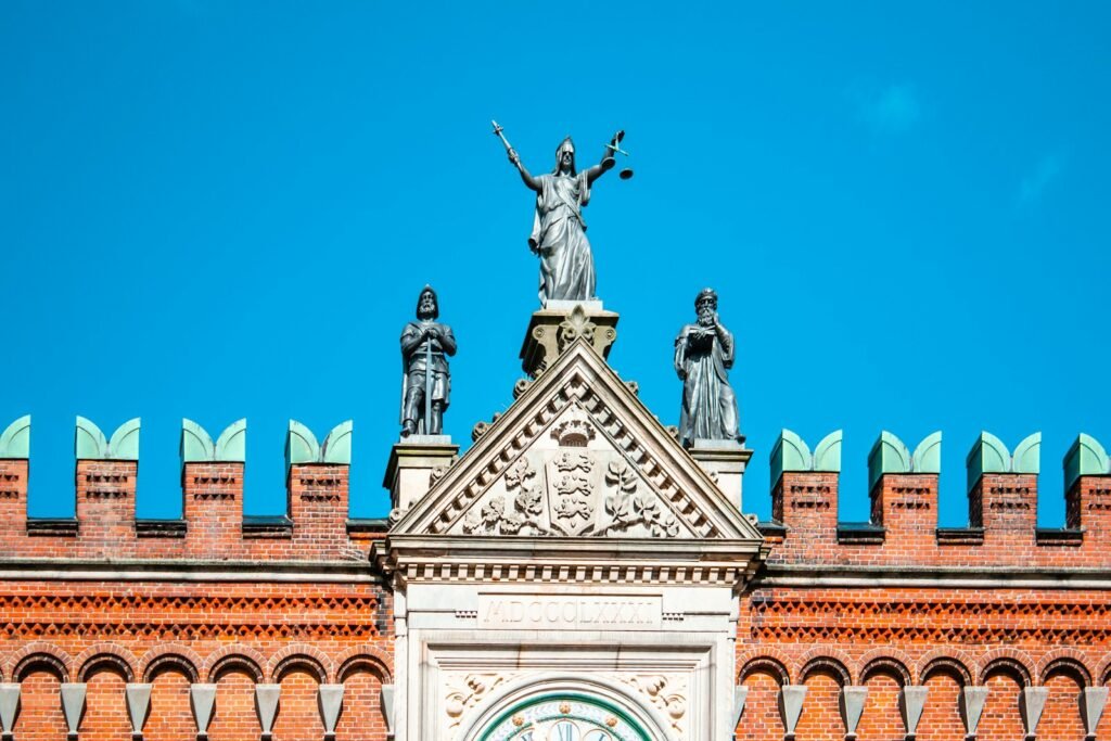 Lady Justice statue on a courthouse roof, a symbol of Bard PowerPort verdicts and post-trial review