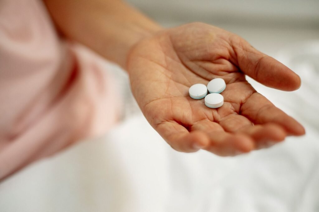 Tylenol autism lawsuit update: open hand holding three white pain reliever tablets