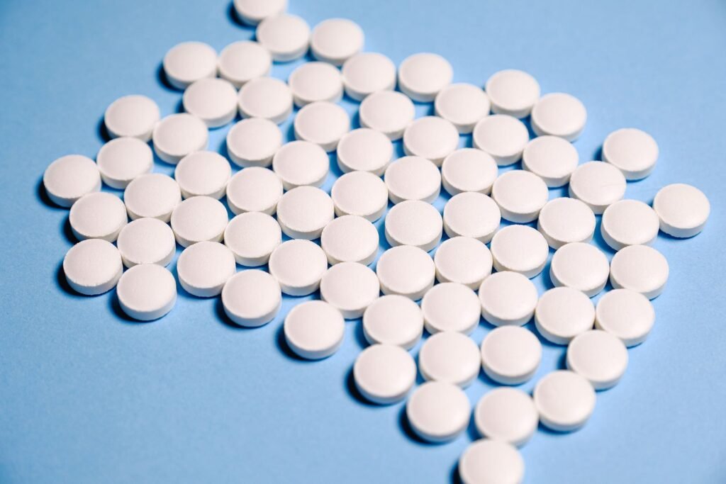 Plain white tablets on a blue cloth, illustrating a Tylenol autism lawsuit update about acetaminophen