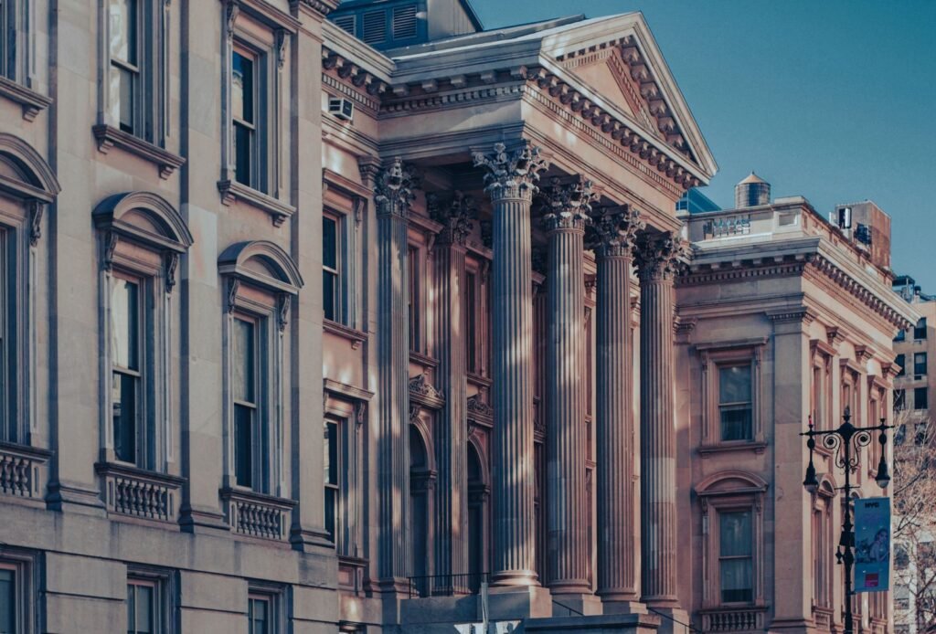 Neoclassical courthouse facade at dusk, representing the courts where Uber and Lyft assault lawsuits are heard