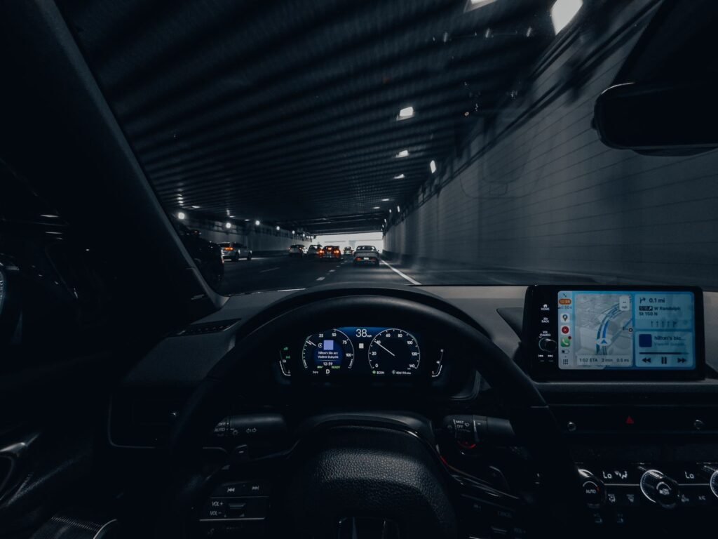 Car dashboard with GPS while driving through a lit tunnel at night, the kind of ride at issue in Uber and Lyft lawsuits