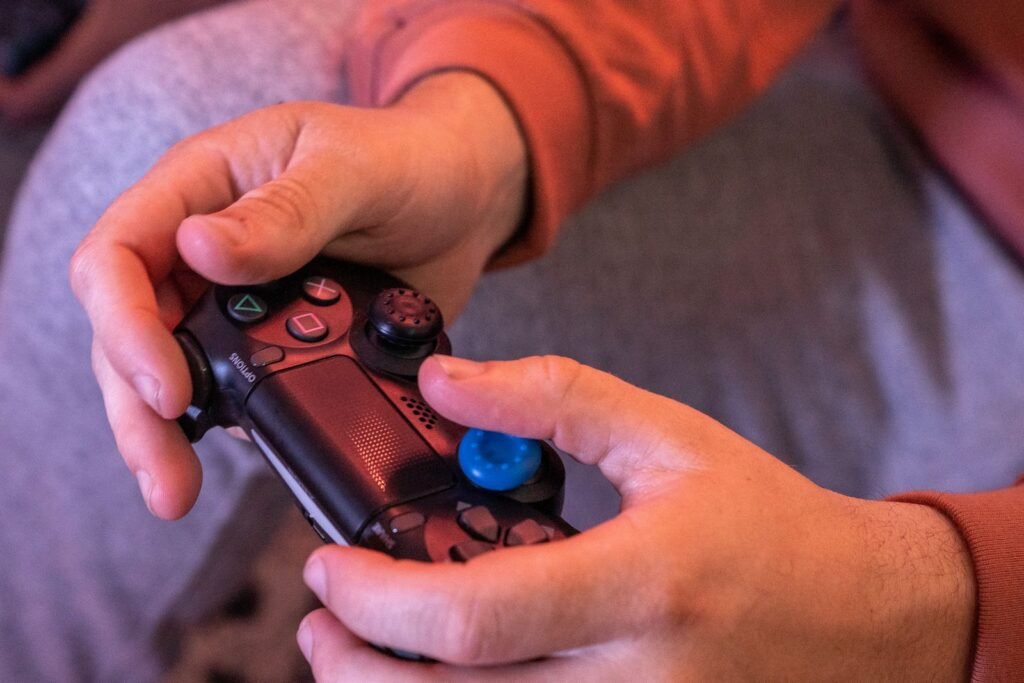 Video game addiction lawsuit status: hands gripping a video game controller during a long gaming session