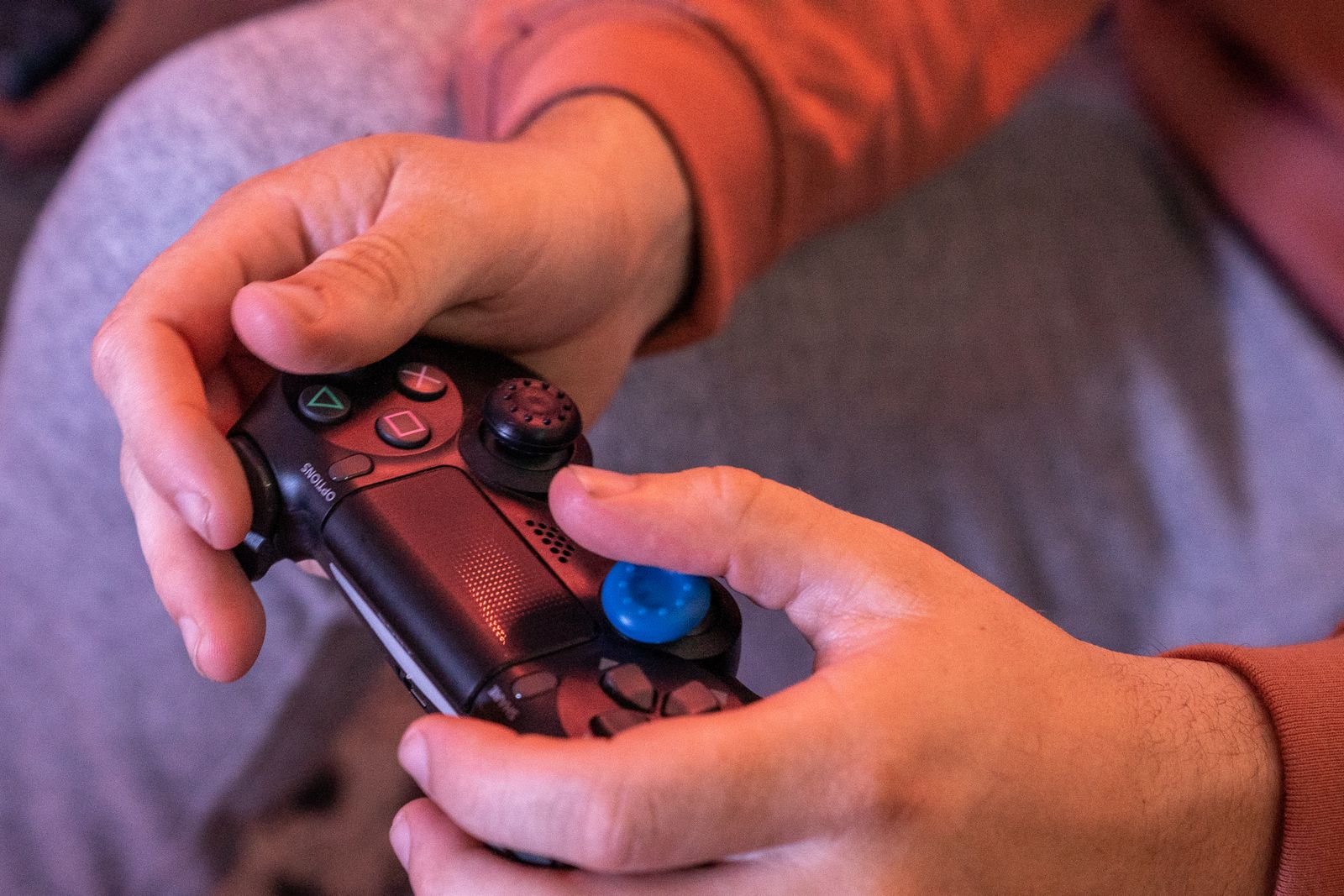 Video game addiction lawsuit status: hands gripping a video game controller during a long gaming session