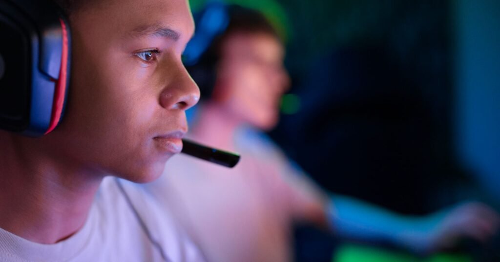 Teenager wearing a gaming headset playing video games