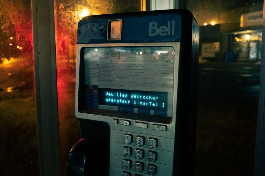 Phone glowing by a window at night, a reminder to watch for warning signs a child is targeted online
