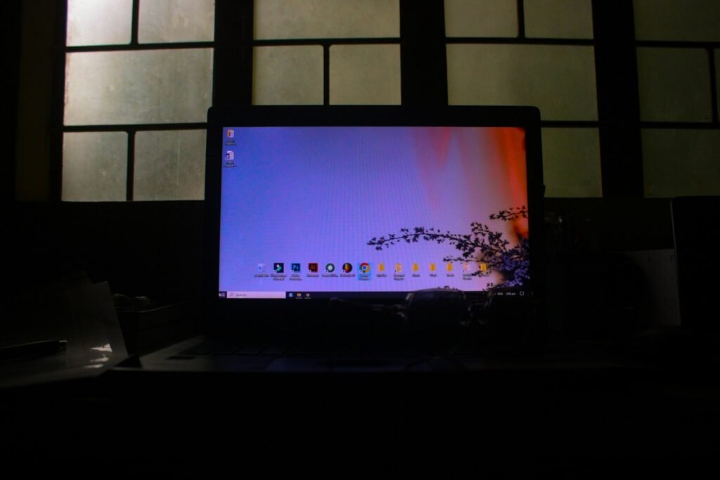Laptop screen glowing in a dark room, showing a home computer that may need safety settings