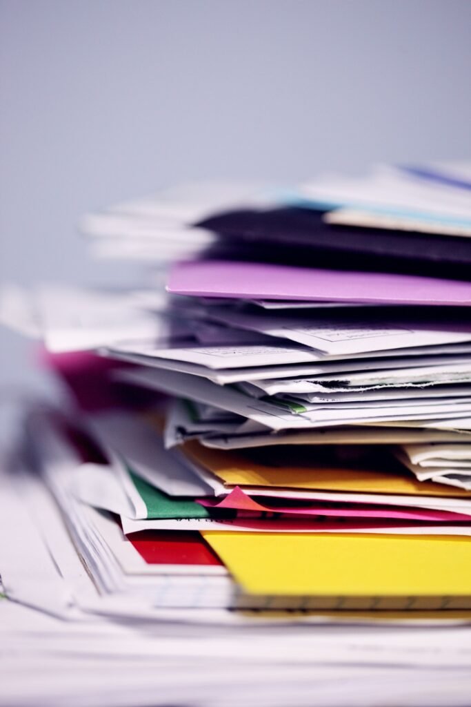 Pile of mail and envelopes waiting to be sorted, like notices about a Depo-Provera settlement claim