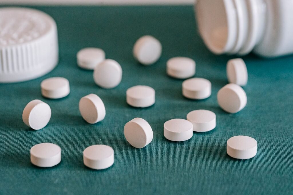 White round pills spilled from a plastic bottle, representing ranitidine claims in the Zantac settlement